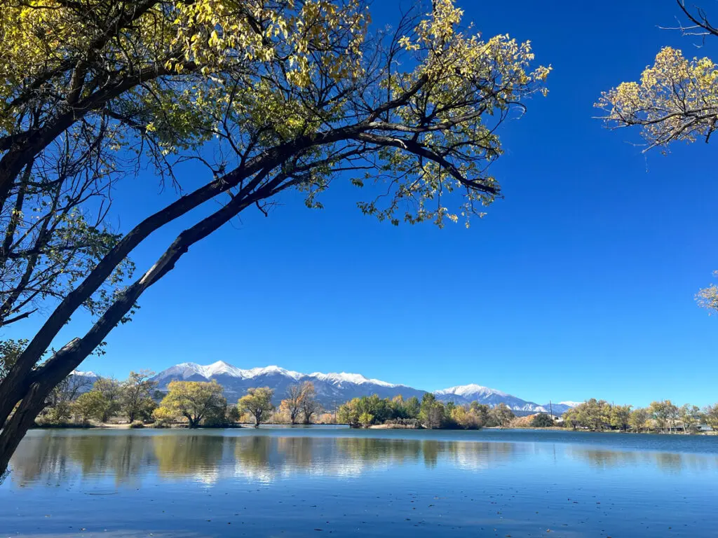 snow capped mountains as viewed from Frantz Lake in Salida Colorado