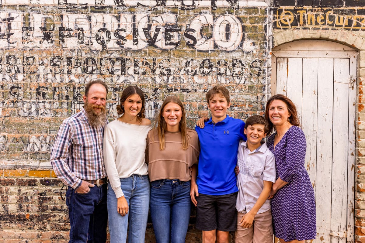 Woodland Motel – Downtown Salida Colorado Motel Hotel - The Bakers family photo in front of old brick building